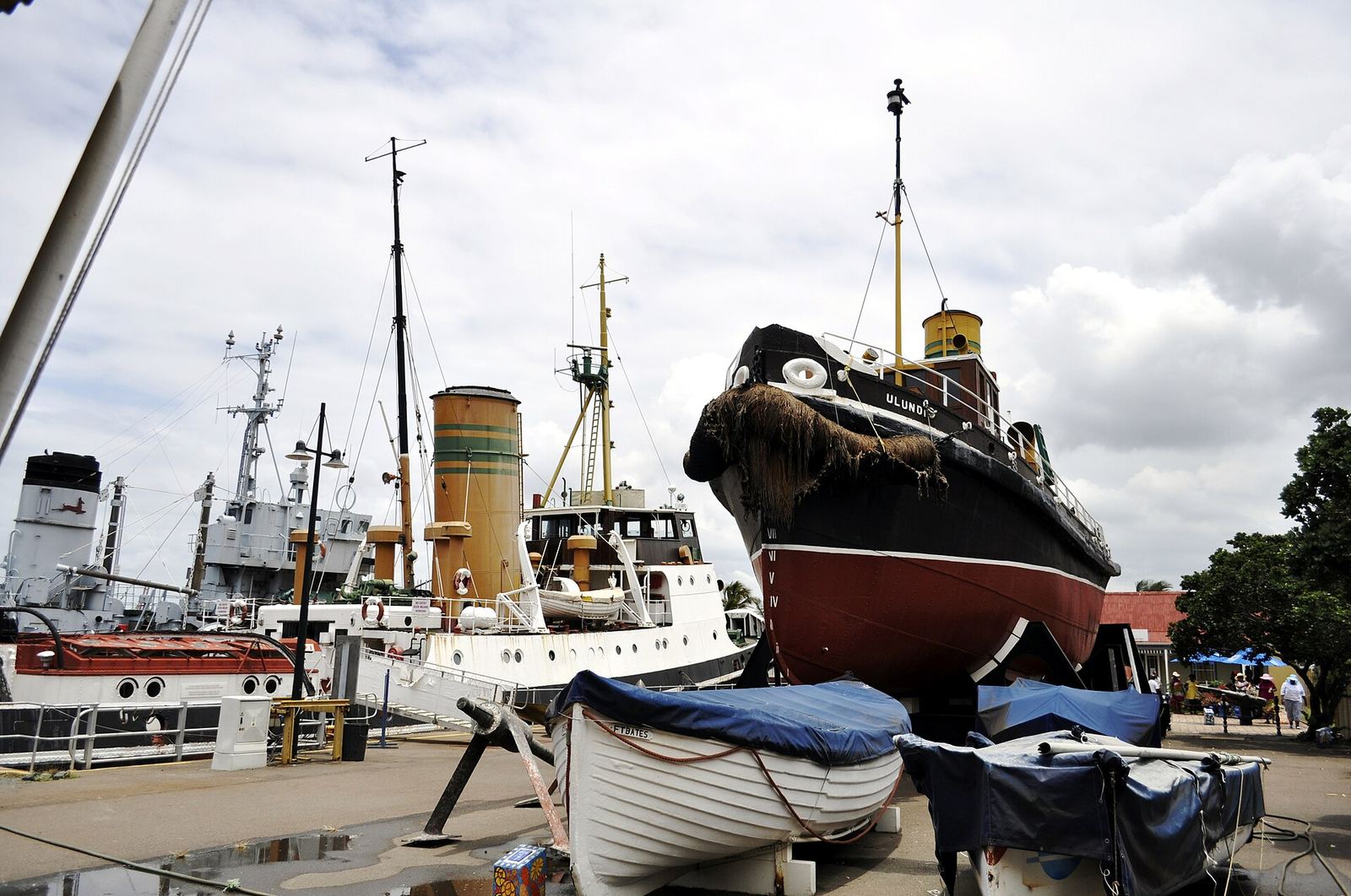 Museum vessels and small boats displayed on the quayside at the Port Natal Maritime Museum