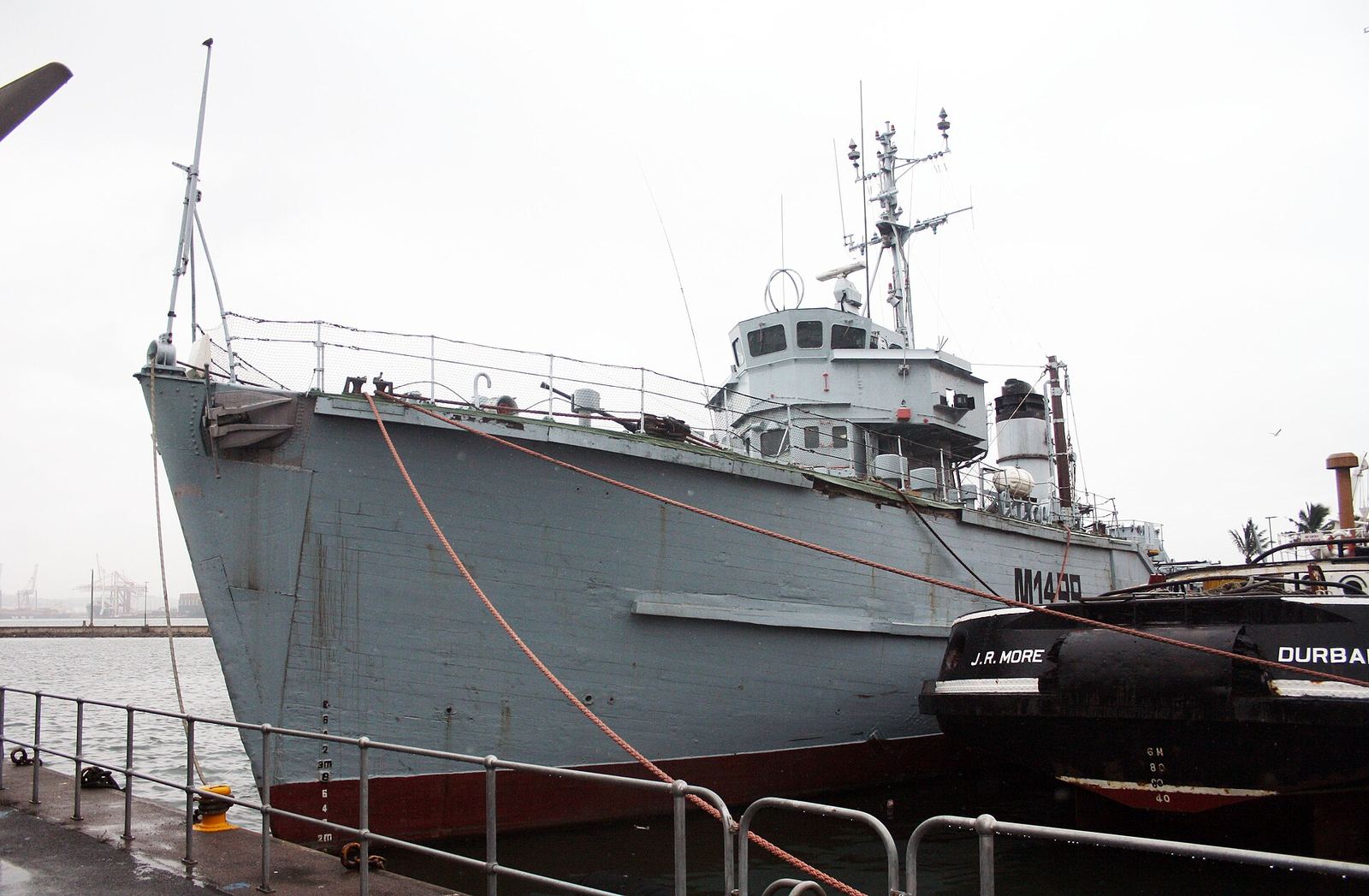 The grey minesweeper SAS Durban moored at the Port Natal Maritime Museum